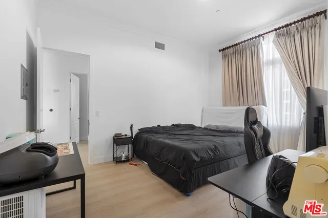 a bedroom with two beds and a dresser