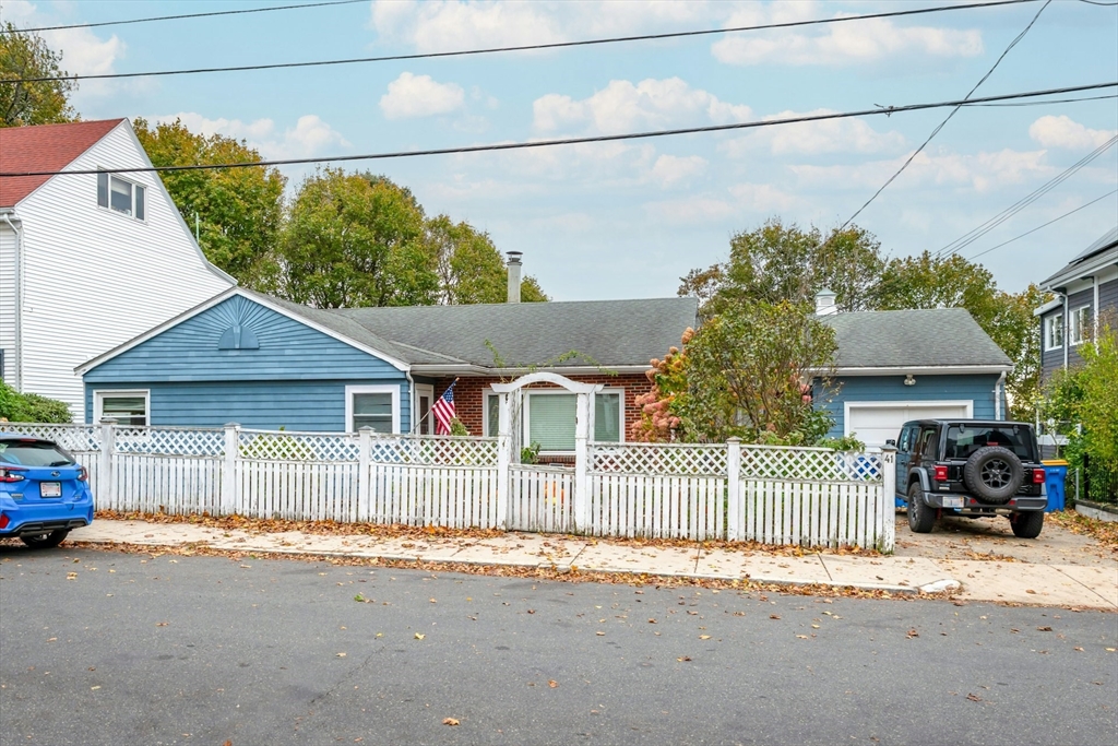 a front view of a house with a garden and pathway