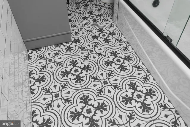 a bathroom with a window and a mirror