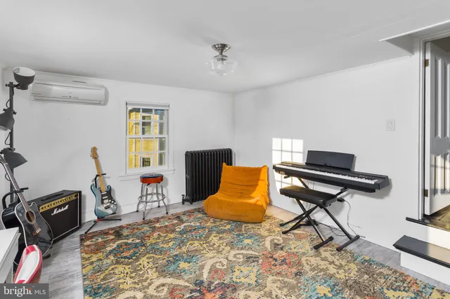 a living room with furniture and a piano