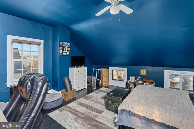 a bed room with furniture and a flat screen tv