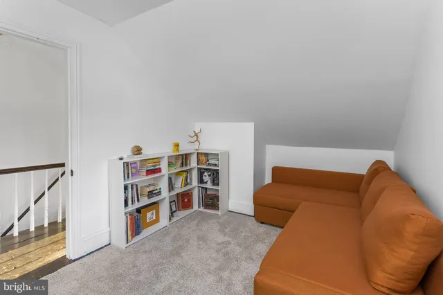 a living room with a couch and a book shelf