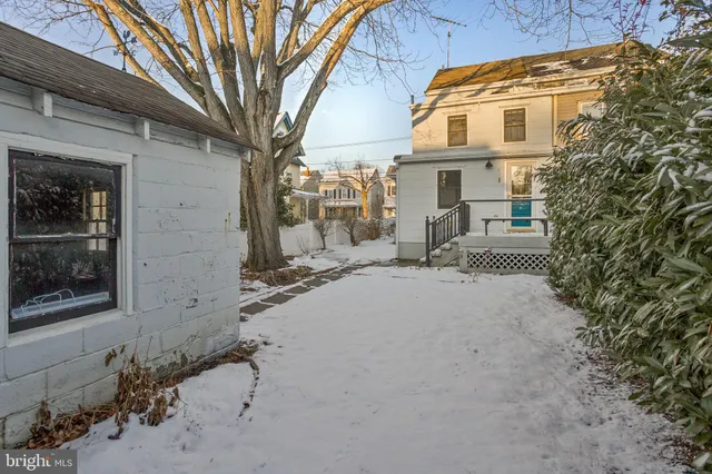 a view of a brick house with a large tree
