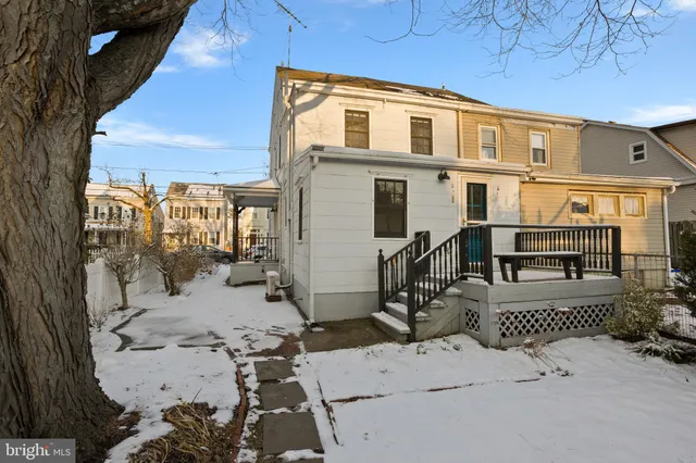 a view of a patio with a table and chairs and potted plants