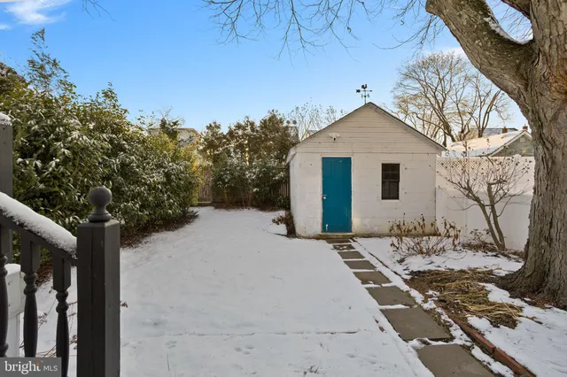 a view of a white house with a yard