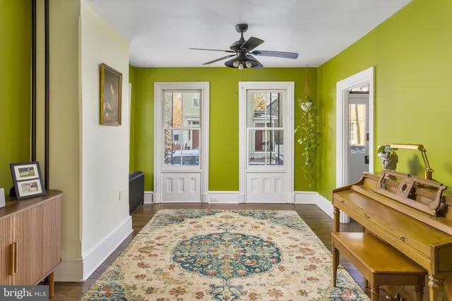 a view of a bedroom with wooden floor and windows