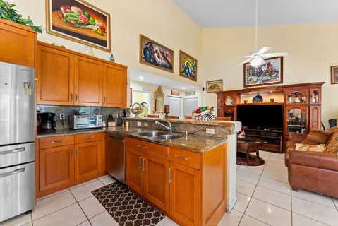 a kitchen with stainless steel appliances granite countertop a refrigerator stove and microwave
