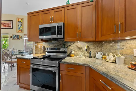 a kitchen with granite countertop a refrigerator and a sink