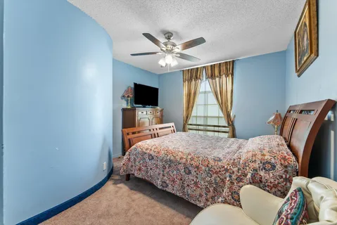 a bedroom with a bed and dresser with mirror