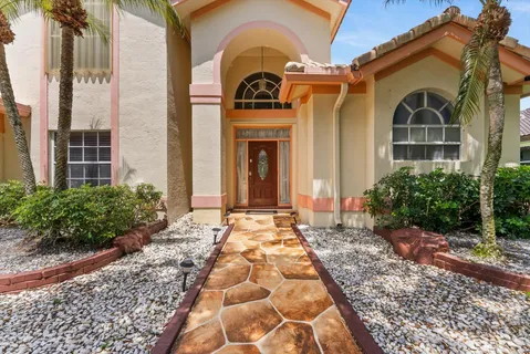 a view of a brick house with large windows