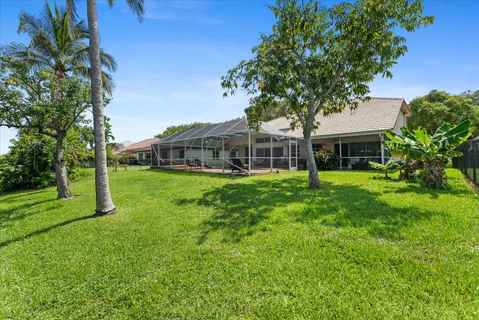 an aerial view of lake and residential houses with outdoor space