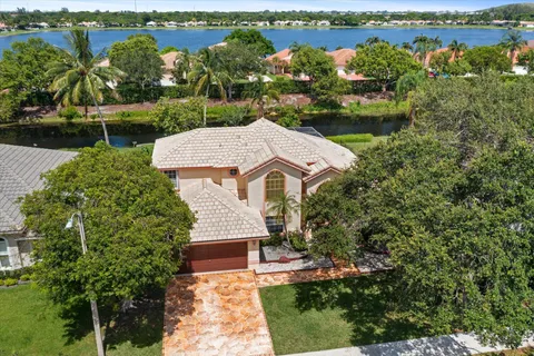 an aerial view of lake and residential houses with outdoor space