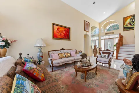 a living room with furniture a rug and a painting on the wall