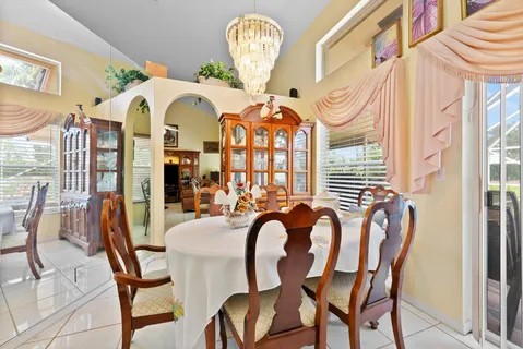 a view of a dining room with furniture and chandelier