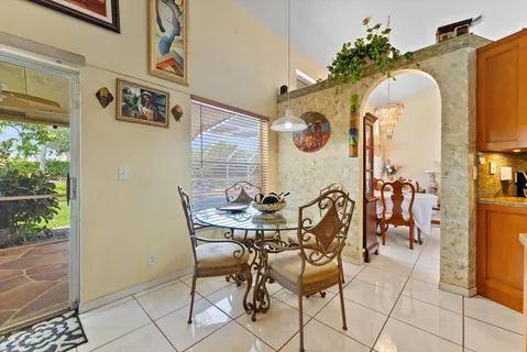 a view of a dining room with furniture and a kitchen