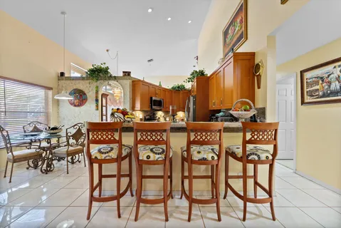 a kitchen with stainless steel appliances granite countertop a stove top oven a sink dishwasher and cabinets with wooden floor