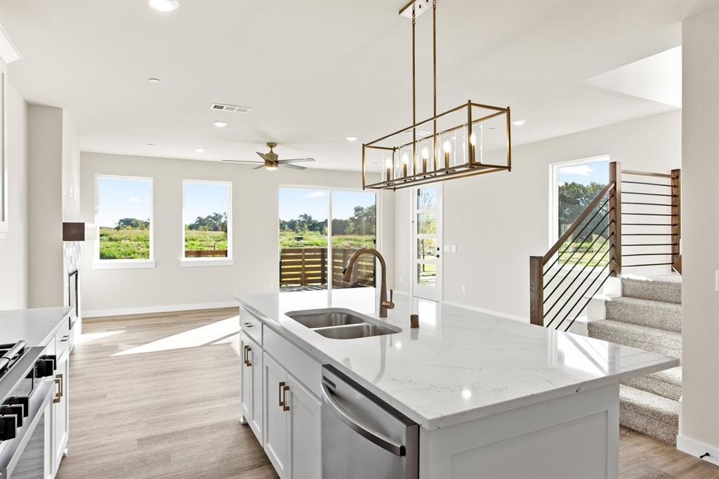 2028 Aldrich Road Celina, TX 75009 - Photo 16 of 40 a kitchen with granite countertop a sink and a window