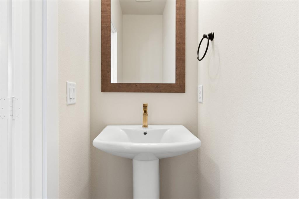 2028 Aldrich Road Celina, TX 75009 - Photo 17 of 40 a bathroom with a sink and a mirror