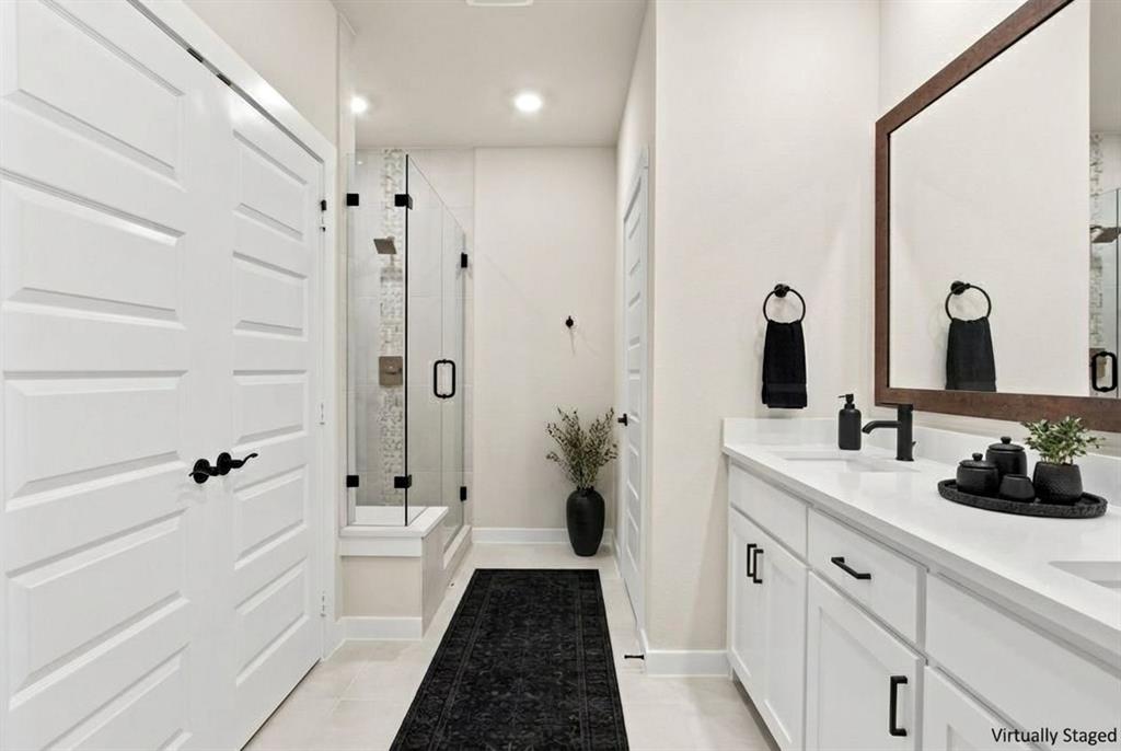 2028 Aldrich Road Celina, TX 75009 - Photo 25 of 40 a bathroom with a double vanity sink a toilet a shower and a mirror