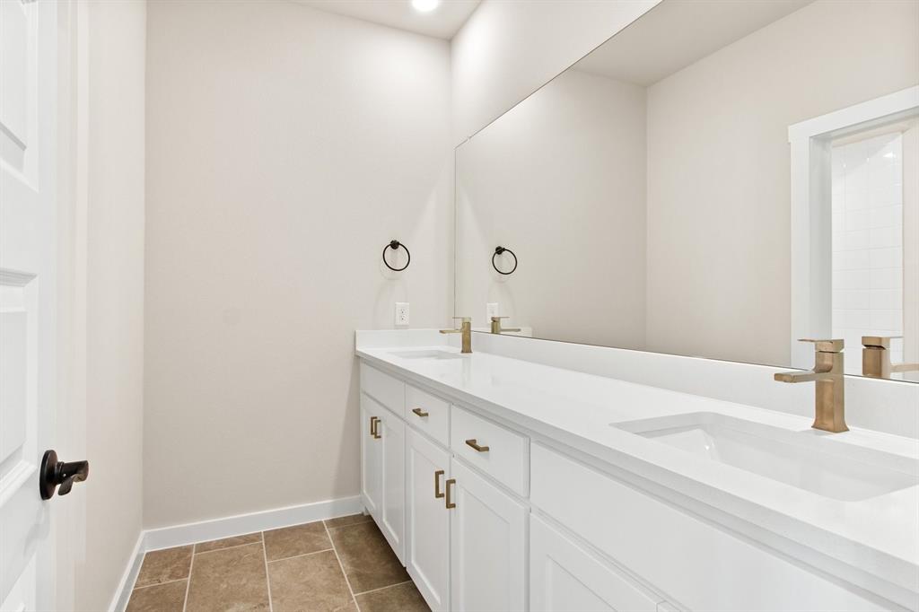 2028 Aldrich Road Celina, TX 75009 - Photo 32 of 40 a bathroom with a sink and a mirror