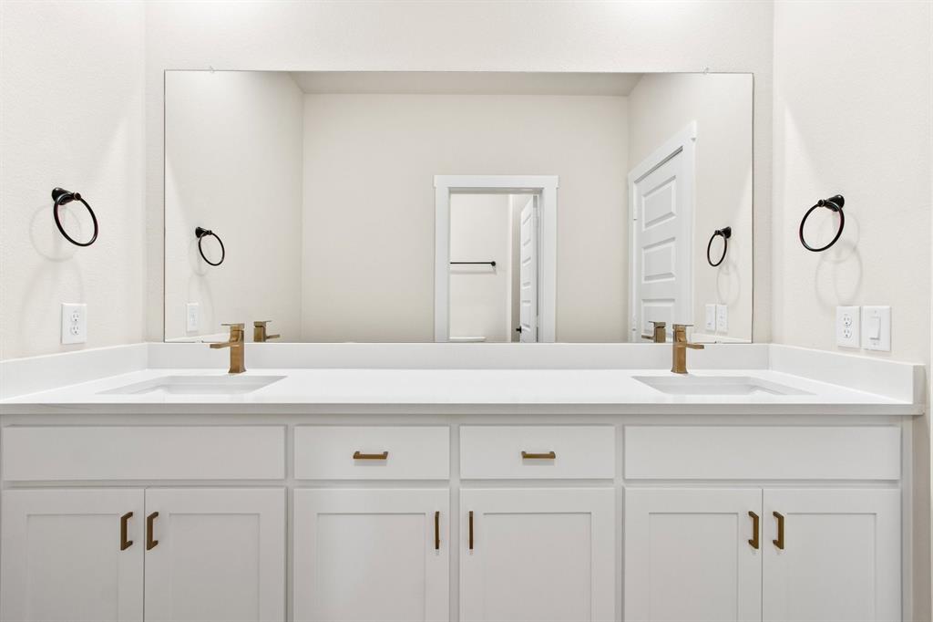 2028 Aldrich Road Celina, TX 75009 - Photo 33 of 40 a bathroom with a sink and a mirror