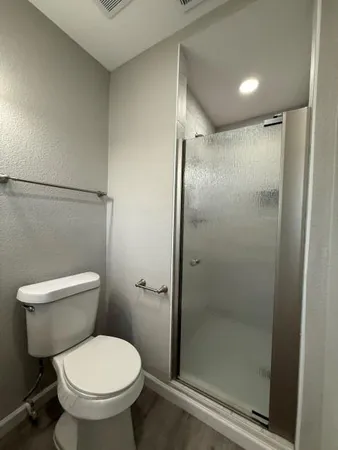 a bathroom with a toilet and a shower