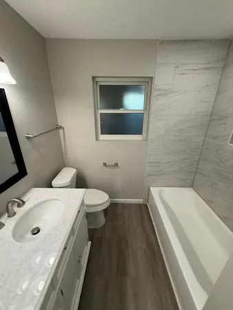 a bathroom with a sink a toilet and mirror
