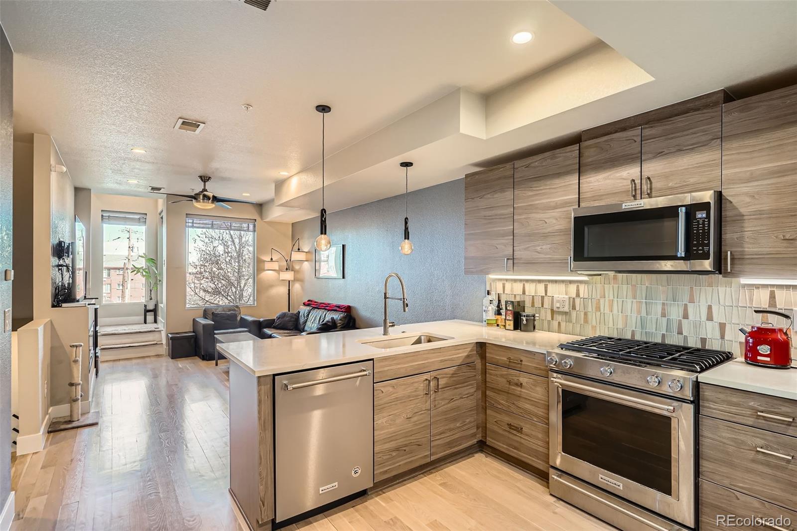1583 Grove Street, Unit 5 Denver, CO 80204 - Photo 12 of 39 a kitchen that has a sink and a stove in it