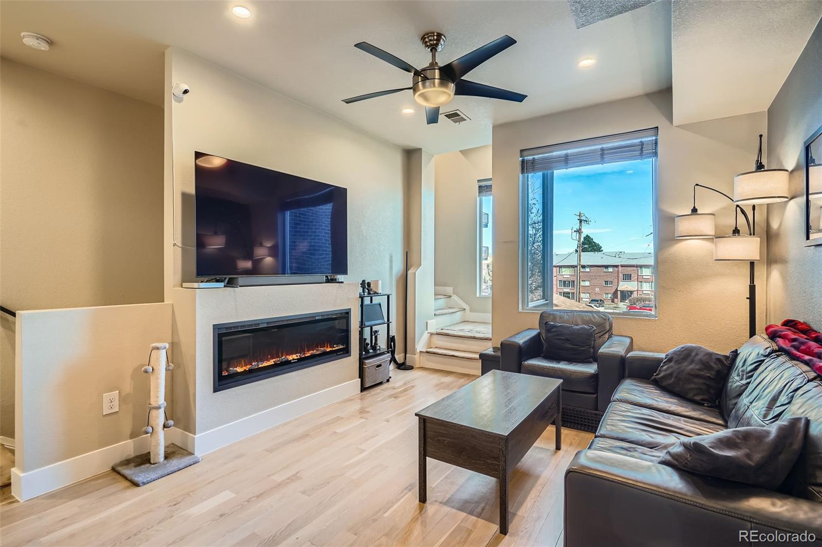 1583 Grove Street, Unit 5 Denver, CO 80204 - Photo 7 of 39 a living room with furniture a flat screen tv and a fireplace