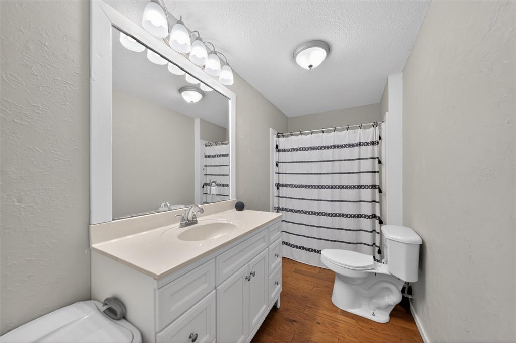 23363 Wateridge Loop Flint, TX 75762 - Photo 30 of 40 a bathroom with a sink a toilet and mirror