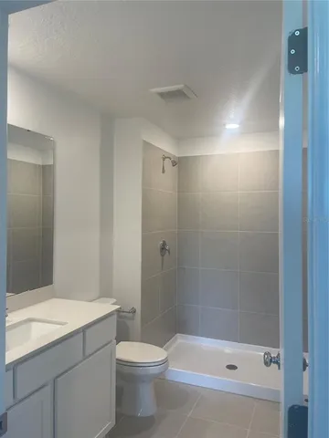 a bathroom with a shower a toilet and sink