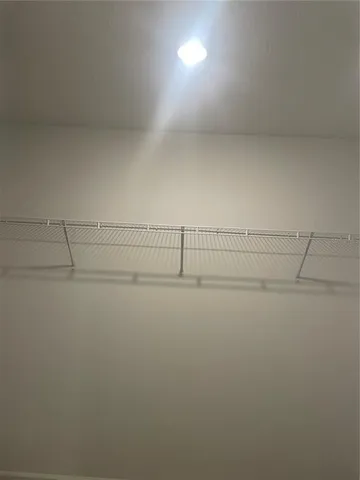 a view of a refrigerator with white walls