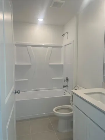 a bathroom with a toilet a sink and bathtub