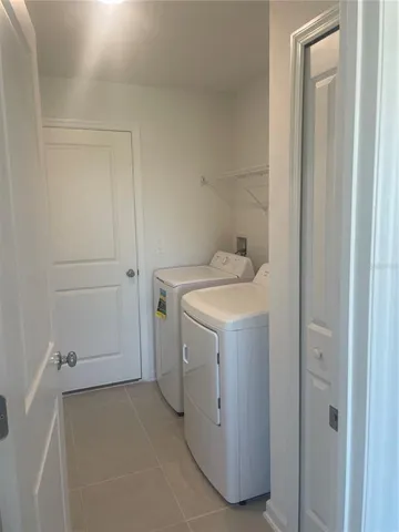 a view of a field with a tree in a yard