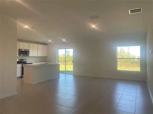 a view of a kitchen and an entryway