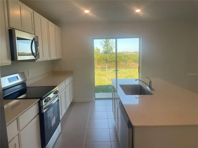 a kitchen that has a sink and a stove