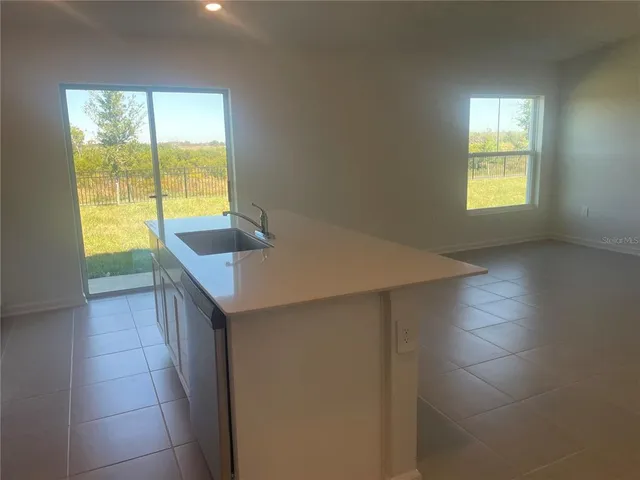a kitchen with a sink and large window