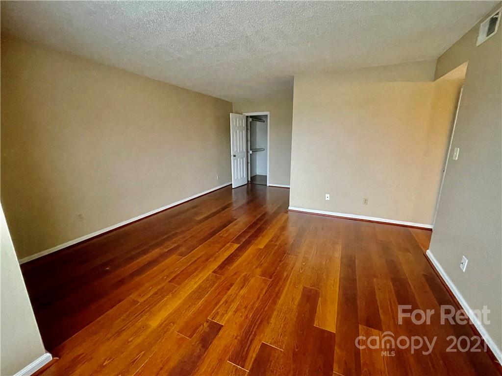 11046 Running Ridge Road Charlotte, NC 28226 - Photo 11 of 15 a view of an empty room with wooden floor