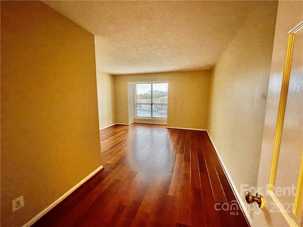 11046 Running Ridge Road Charlotte, NC 28226 - Photo 12 of 15 a view of a room with wooden floor and brick walls