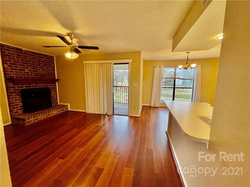 11046 Running Ridge Road Charlotte, NC 28226 - Photo 5 of 15 a view of a livingroom with wooden floor and a ceiling fan