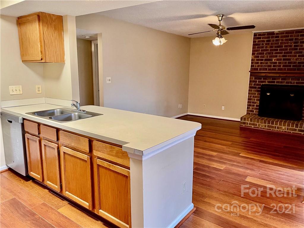 11046 Running Ridge Road Charlotte, NC 28226 - Photo 7 of 15 a kitchen that has a sink and a stove in it