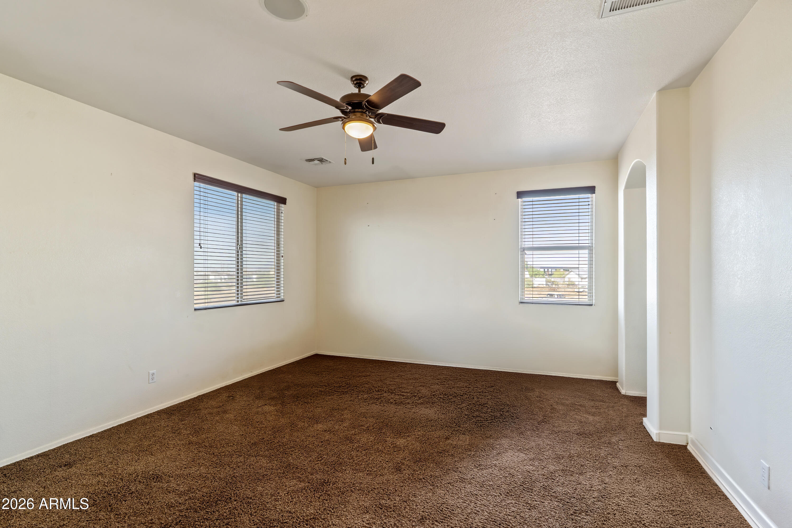 7634 West Apollo Road Laveen, AZ 85339 - Photo 17 of 34 a view of a room with window and ceiling fan