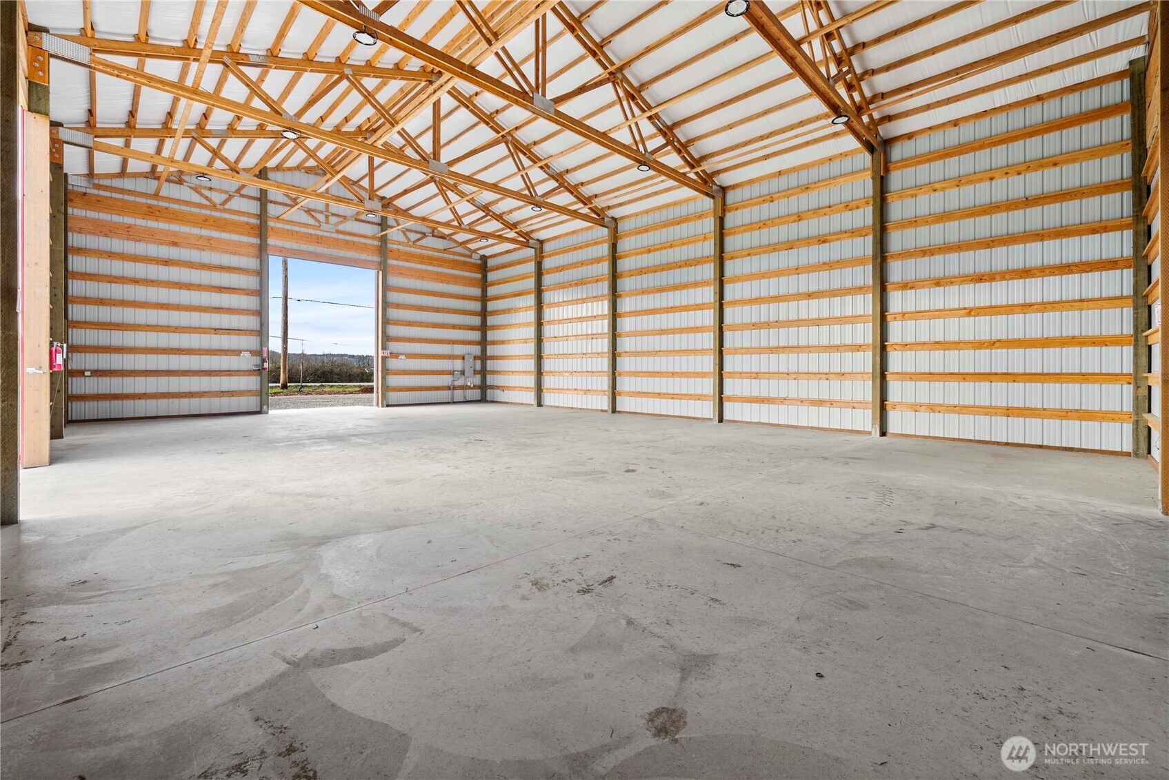 19403 Orville Road East Orting, WA 98360 - Photo 12 of 15 a view of an empty room with a fireplace and large windows