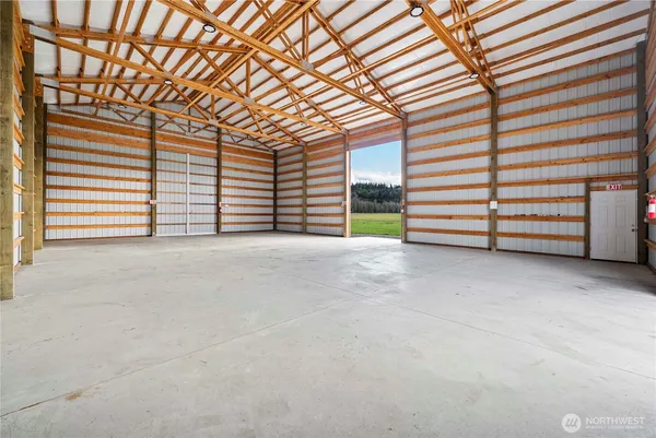 a view of an empty room with a fireplace and large windows