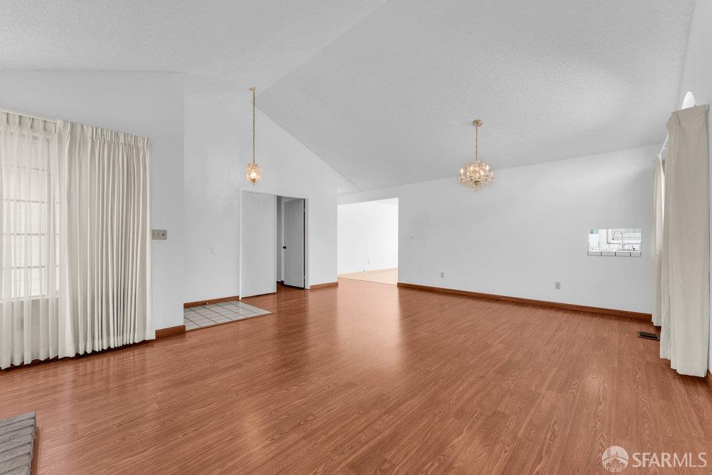 184 Pearce Hercules, CA 94547 - Photo 14 of 61 an empty room with wooden floor and windows