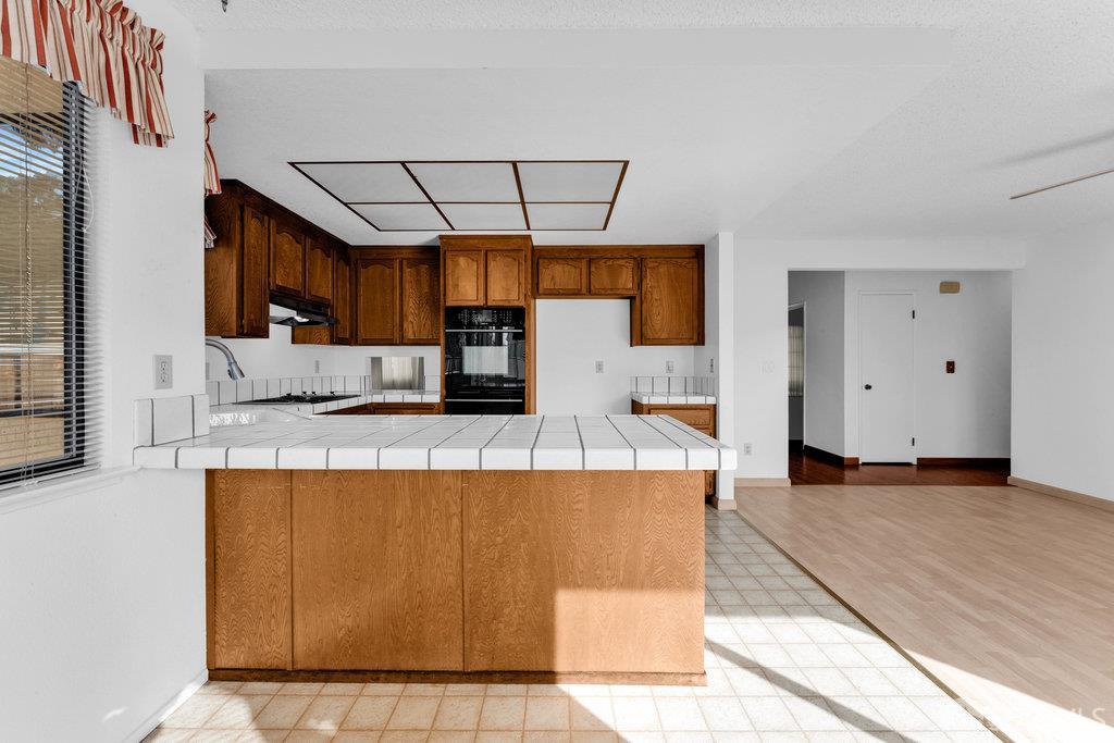 184 Pearce Hercules, CA 94547 - Photo 29 of 61 a view of a kitchen with kitchen island a sink wooden floor and window