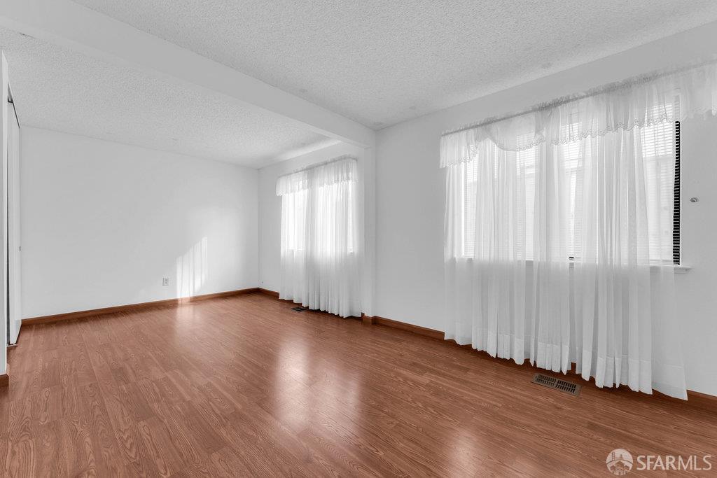 184 Pearce Hercules, CA 94547 - Photo 39 of 61 a view of an empty room with wooden floor and a window