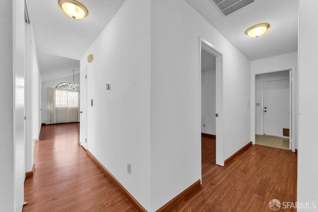 184 Pearce Hercules, CA 94547 - Photo 47 of 61 a view of a hallway with wooden floor