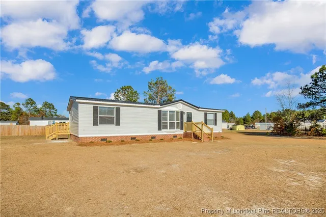 a view of a house with outdoor space and ocean view