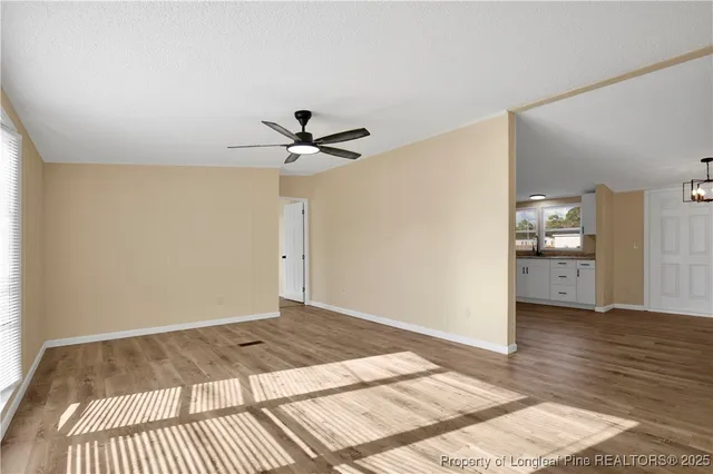 a view of a bedroom with wooden floor and a bathroom